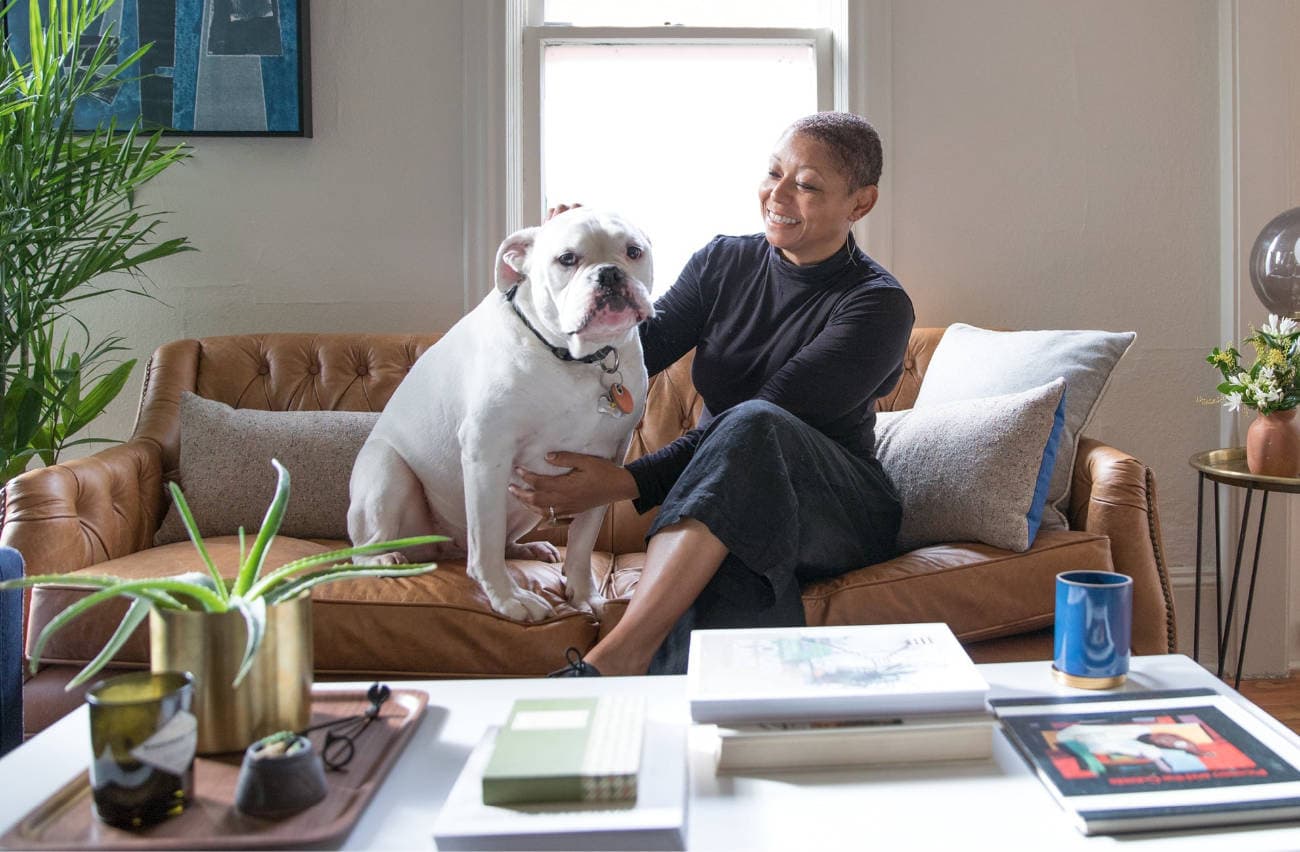 Angela and her dog, Wubbi, sitting on couch